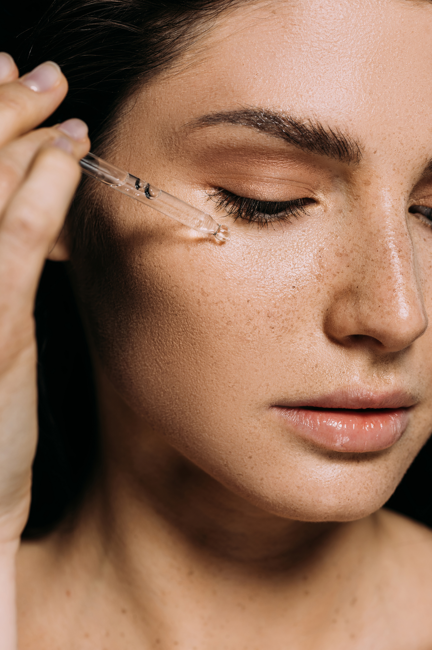 Model using a serum dropper on face