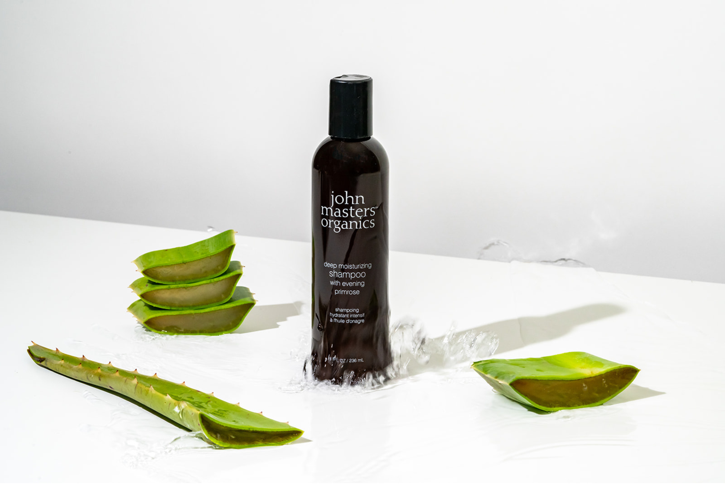 John Masters Organics Deep Moisturizing Shampoo with aloe slices and water